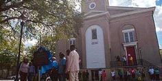 a group of people standing in front of a church