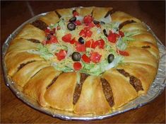 a cake that is sitting on top of a pan with fruit and veggies in it