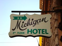 the michigan hotel sign is hanging from the building