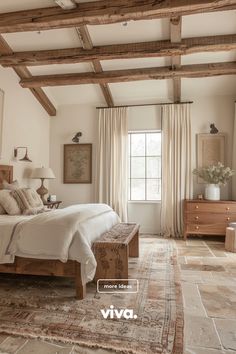 a large bed sitting under a wooden beam in a bedroom next to a dresser and window