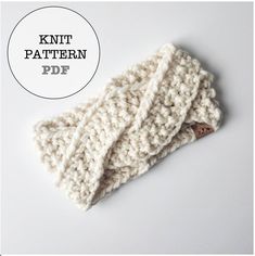 a knitted headband with buttons on the front and side, in white yarn