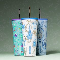 three different colored cups with straws in them