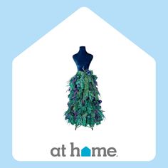 a mannequin is dressed up in a dress made out of green and purple feathers