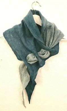 a blue and grey scarf hanging on a wall