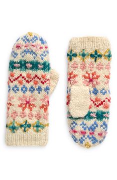 two knit mittens with colorful designs on them, one is white and the other is pink