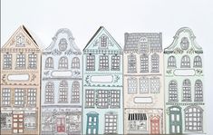 a group of paper houses sitting next to each other