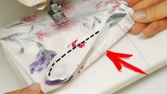 someone is using a sewing machine to sew something on the tablecloth with red arrows