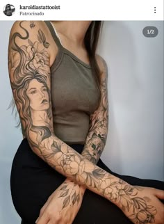 a woman with tattoos on her arm sitting down