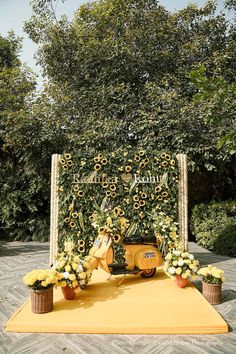 a scooter decorated with sunflowers and greenery sits on a yellow carpet