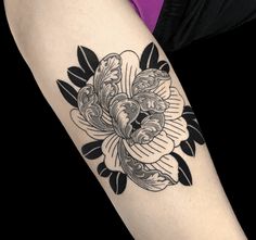 a woman's arm with a flower tattoo on the left side of her body