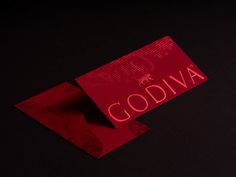 a red business card with the word godiva on it