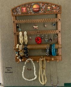 a wall mounted jewelry rack with beads and bracelets