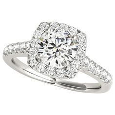 a diamond engagement ring with two rows of diamonds on the band and an halo setting