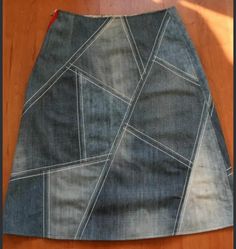 a skirt made out of old jeans is sitting on the floor next to a pair of scissors