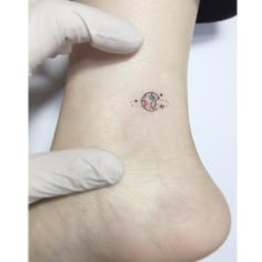 a person with a small tattoo on their left side of the leg, and an arm