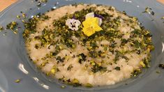 a blue plate topped with rice and flowers