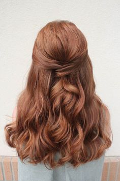 the back of a woman's head with wavy red hair