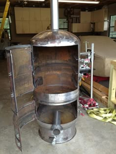 a large metal stove sitting inside of a garage