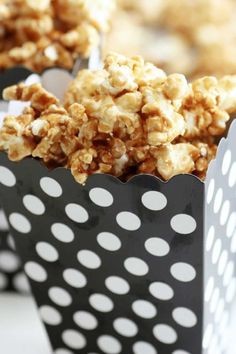 three black and white boxes filled with popcorn