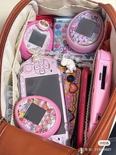 a purse filled with lots of different types of electronic devices