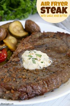 steak with garlic herb butter and vegetables on a white plate, with the words air fryer steak written above it