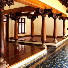 an ornately decorated room with columns and tiled floor