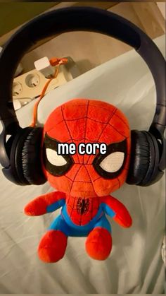 a spiderman stuffed animal with headphones attached to it's ear and the caption me core