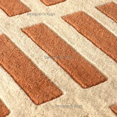 an orange and white area rug with squares on the bottom, diagonals in different directions