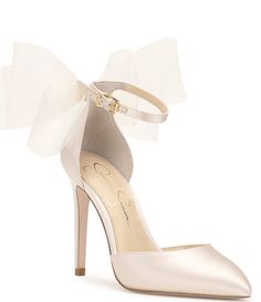 From Jessica Simpson&#x2C; the Phindies Oversized Tulle Bow Dress Pumps feature:Fabric upperOversized tulle bow on the backAnkle strap with buckle closureSynthetic liningSynthetic outsoleApprox. 3.54" heel heightImported. Homecoming Heels, Chasing Pavements, Bow Back Dress, 2024 Wedding Trends, Blush Heels, Tulle Bow, Neutral Heels, Bow Wedding Dress, Jessica Simpson Heels