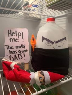 an elf's head is sitting on top of a shelf next to a bottle of milk