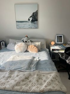 a bedroom with a bed, desk and pictures on the wall