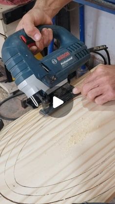 a person using a power tool on a piece of wood