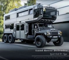 an off road vehicle is parked in front of a building with the words land rover defender on it