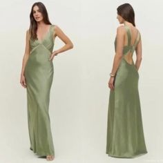 a woman in a long green dress with open back