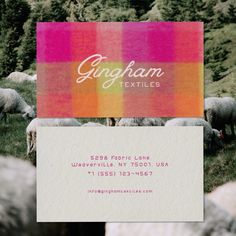 a business card with sheep grazing in the grass and trees behind it that says gingham textiles