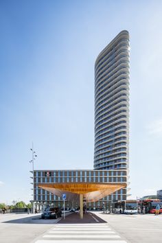 a very tall building sitting in the middle of a parking lot next to a street