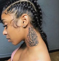 a woman with braids has a tattoo on her neck