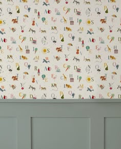 the wall paper has animals and letters on it