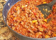 a large pot filled with chili and beans