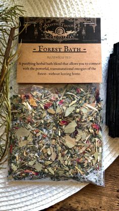 a bag of tea sitting on top of a table next to some dried herbs and leaves