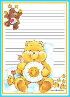 a teddy bear is sitting on top of a notepad with embellishments