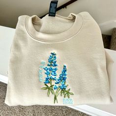 Handmade And Designed By Me S-Xxl Available Sand Color Crewneck 5 Thread Colors Hand Drawn Bluebonnet Texas State Flower Crew Neck Embroidery, Embroidered Items, Bluebonnet Embroidery, Blue Bonnet Embroidery, Blue Long Sleeve Sweatshirt With Floral Embroidery, Embroidered Bluebonnet, Texas Sweatshirt, Embroidered Crewneck, Blue Bonnets