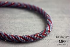 a red, white and blue beaded bracelet on top of a gray countertop