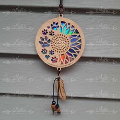 a wooden dream catcher hanging on the side of a building