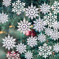 a christmas tree with snowflakes hanging from it's branches