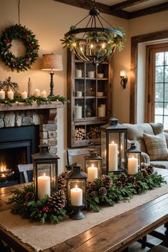 a table topped with candles and christmas wreaths next to a fire place in front of a fireplace