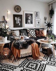 a black and white living room with pictures on the wall, rugs, tables and chairs