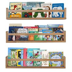 three wooden bookshelves filled with children's books