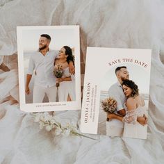 two save the date cards on top of a bed next to flowers and a bouquet