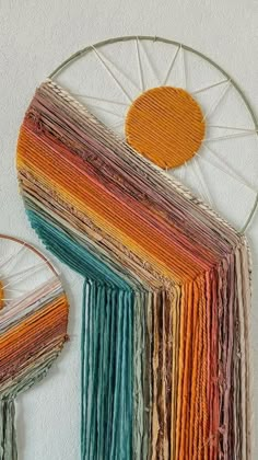 a multicolored wall hanging next to a circular object